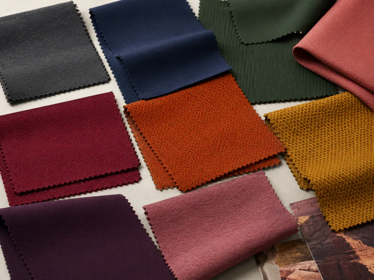 Squat-proof legging fabric opacity test comparing dark and light nylon-spandex swatches